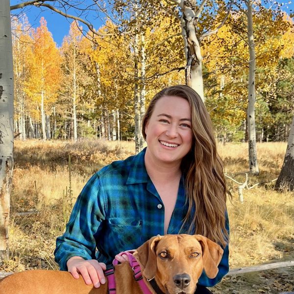 Lauren Orme with her dog. Yellow aspens can be seen in the background.